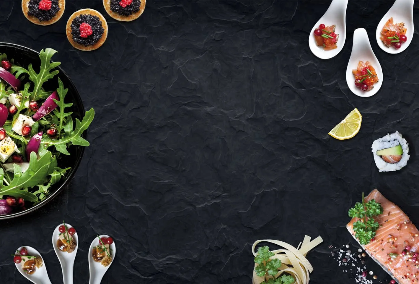 Gourmet catering spread on slate — salad, canapés and seafood